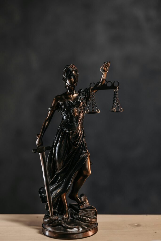 Elegant bronze Lady Justice statuette symbolizing law and justice.